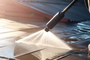 A homeowner reviews a clean stucco exterior and screened patio beside professional cleaning equipment.